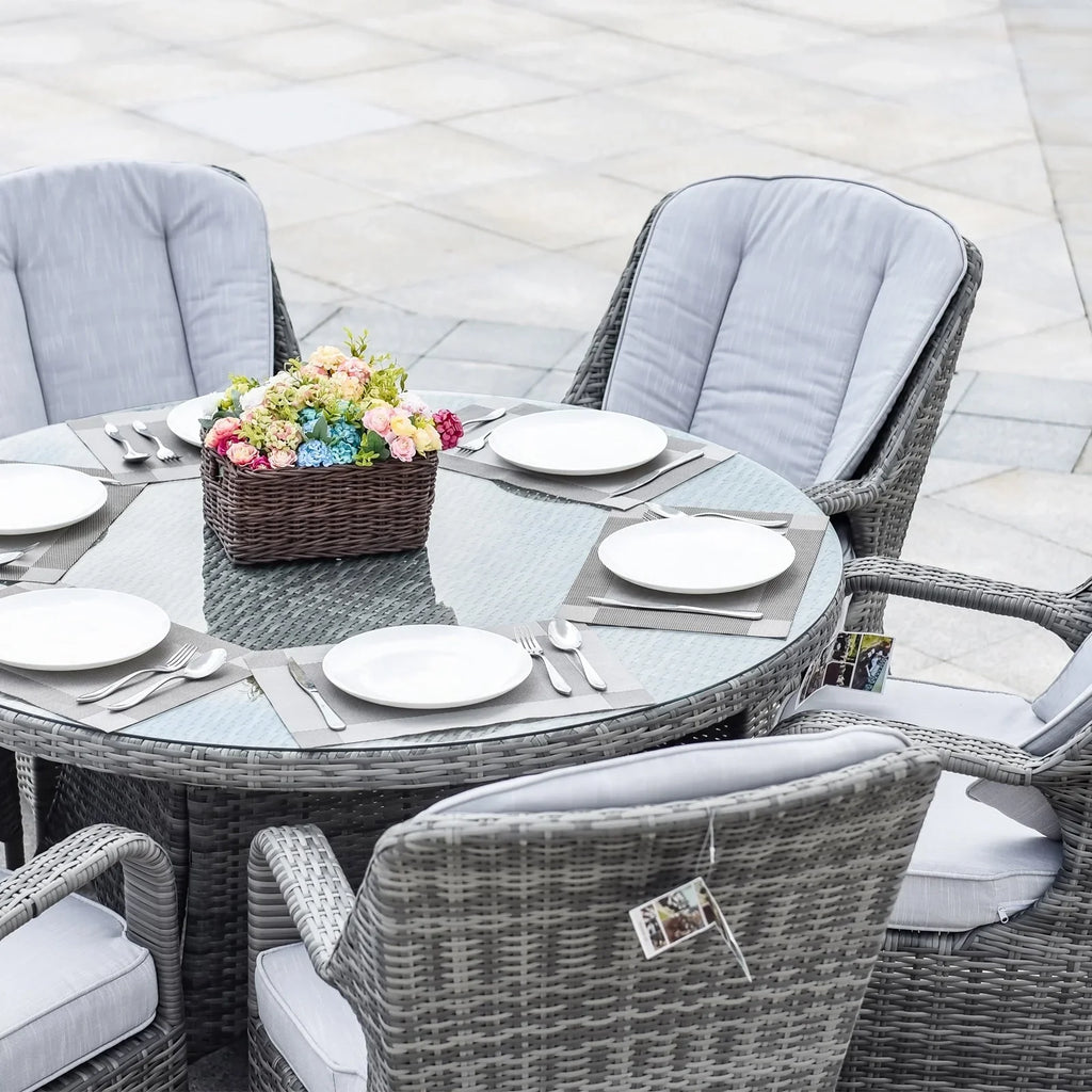Set da pranzo rotondo da esterno in rattan intrecciato da 7 pezzi con cuscini di Moda Furnishings